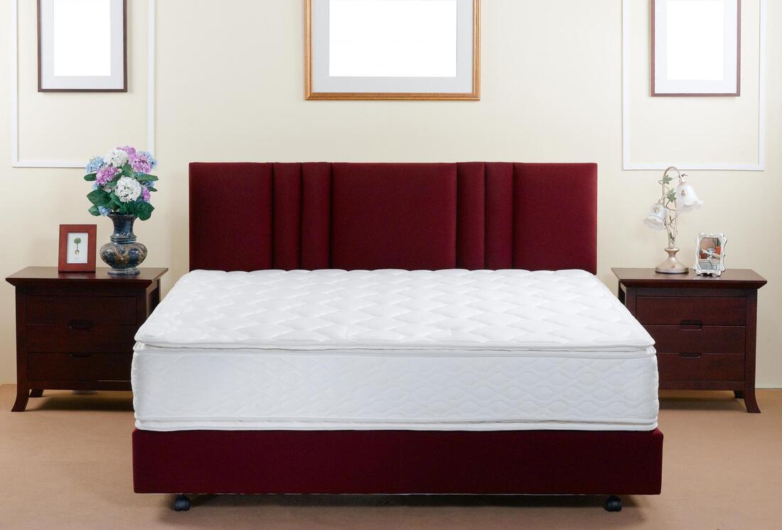 a clean white and maroon bedroom
