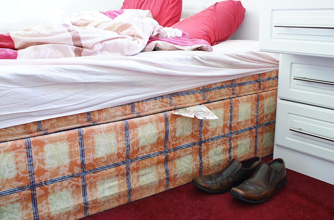 white bed mattress with brown shoes on the side 
